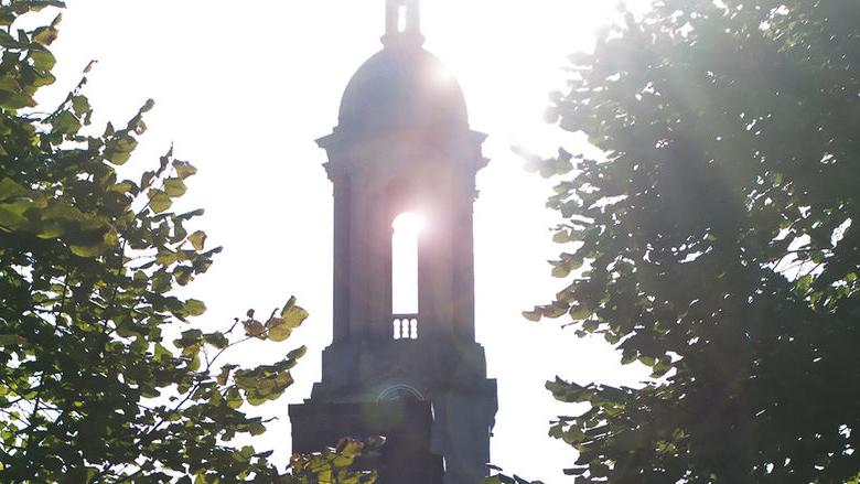 Sun streaming through Penn State's Old Main bell tower